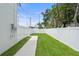 Backyard with a white privacy fence and newly installed lawn at 5055 2Nd S Ave, St Petersburg, FL 33707