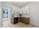 Chic bar area featuring custom cabinets, wine cooler, and sleek countertops perfect for entertaining guests at 5055 2Nd S Ave, St Petersburg, FL 33707