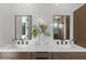 Elegant bathroom featuring double vanities, decorative mirrors, with stylish lighting fixtures at 5055 2Nd S Ave, St Petersburg, FL 33707