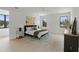 Bright bedroom features a modern bed, stylish décor, and two large windows offering plenty of natural light at 5055 2Nd S Ave, St Petersburg, FL 33707