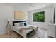 Sun-filled bedroom showcasing a luxurious bed, sleek furniture, and large windows with scenic views at 5055 2Nd S Ave, St Petersburg, FL 33707