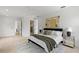 Spacious bedroom with en-suite bathroom features neutral decor, a modern bed, and elegant furnishings at 5055 2Nd S Ave, St Petersburg, FL 33707