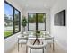 Bright dining room featuring modern glass table, stylish chairs, and large windows offering natural light at 5055 2Nd S Ave, St Petersburg, FL 33707