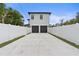 Features a spacious driveway leading to a two-car garage, enclosed by a crisp white fence at 5055 2Nd S Ave, St Petersburg, FL 33707
