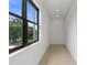 Hallway featuring a large window with outside views, neutral colors, and hardwood floors at 5055 2Nd S Ave, St Petersburg, FL 33707
