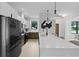 Elegant kitchen with quartz countertops, modern black appliances, pendant lighting and an island with bar stools at 5055 2Nd S Ave, St Petersburg, FL 33707