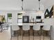 Modern kitchen features a large center island with bar seating, pendant lighting, and stainless steel appliances at 5055 2Nd S Ave, St Petersburg, FL 33707