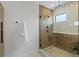 Modern shower features decorative tile, black hardware, a built-in bench, and a glass enclosure at 5055 2Nd S Ave, St Petersburg, FL 33707