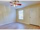 Bedroom with neutral walls, light wood floors, ceiling fan and window at 5915 Brickleberry Ln # 103, Zephyrhills, FL 33541
