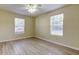Bright bedroom with ceiling fan, light walls, and windows for natural light at 5915 Brickleberry Ln # 103, Zephyrhills, FL 33541