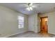 Bedroom with ceiling fan, neutral walls, and ensuite bathroom access at 5915 Brickleberry Ln # 103, Zephyrhills, FL 33541