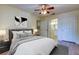 Bright bedroom features neutral paint, ceiling fan, updated lamps and laminate flooring at 5915 Brickleberry Ln # 103, Zephyrhills, FL 33541