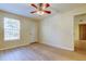 Bedroom featuring a ceiling fan, a window, and wood flooring at 5915 Brickleberry Ln # 103, Zephyrhills, FL 33541