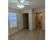 Comfortable bedroom with vinyl floors, closet, and a ceiling fan for optimal air circulation at 5915 Brickleberry Ln # 103, Zephyrhills, FL 33541