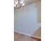 Bright dining area with a chandelier, neutral walls, and wood-look flooring at 5915 Brickleberry Ln # 103, Zephyrhills, FL 33541