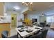 Dining room with table set for six, laminate flooring and kitchen, living room access at 5915 Brickleberry Ln # 103, Zephyrhills, FL 33541