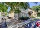 Exterior view of building, featuring neutral paint and a covered entry with landscape and parking at 5915 Brickleberry Ln # 103, Zephyrhills, FL 33541