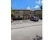 Two-story townhome featuring neutral stucco, ample parking, and close proximity to community amenities at 5915 Brickleberry Ln # 103, Zephyrhills, FL 33541
