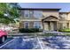 Two-story building featuring neutral paint and a covered entry. Landscaped yard and ample parking at 5915 Brickleberry Ln # 103, Zephyrhills, FL 33541