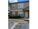 Close up of the townhome, showcasing manicured landscaping and reserved parking at 5915 Brickleberry Ln # 103, Zephyrhills, FL 33541