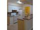 Well-equipped kitchen with modern appliances, tile backsplash and adjacent laundry room at 5915 Brickleberry Ln # 103, Zephyrhills, FL 33541
