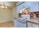 Bright kitchen featuring white appliances, ample cabinet space and decorative tile backsplash at 5915 Brickleberry Ln # 103, Zephyrhills, FL 33541