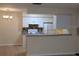 Open kitchen featuring white cabinets, tile backsplash, and stainless steel appliances at 5915 Brickleberry Ln # 103, Zephyrhills, FL 33541
