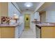 Open kitchen showcases white cabinets, appliances, and laminate flooring plus a window over the sink at 5915 Brickleberry Ln # 103, Zephyrhills, FL 33541