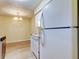 A bright kitchen showcases white appliances including a large refrigerator, range and dining area at 5915 Brickleberry Ln # 103, Zephyrhills, FL 33541