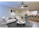Bright living room boasts an open floor plan with modern furnishings and a ceiling fan at 5915 Brickleberry Ln # 103, Zephyrhills, FL 33541