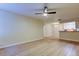 Spacious living room with light wood-look floors and a view of the dining area and kitchen at 5915 Brickleberry Ln # 103, Zephyrhills, FL 33541
