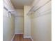 Bright walk-in closet with neutral walls, wood-look flooring, and wire shelving at 5915 Brickleberry Ln # 103, Zephyrhills, FL 33541