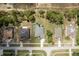 Aerial view of a home with a large, screened pool, well-kept landscaping, and mature trees at 6129 Schalekamp Dr, Spring Hill, FL 34609