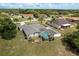 Aerial view of a house with a screened in pool, surrounded by a well maintained green lawn at 6129 Schalekamp Dr, Spring Hill, FL 34609