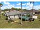 A well-maintained backyard boasts a screened-in pool and a nicely manicured lawn with shade from surrounding palm trees at 6129 Schalekamp Dr, Spring Hill, FL 34609