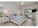 Bright bedroom boasts tiled floors, stylish coastal decor, and sliding glass doors to the pool at 6129 Schalekamp Dr, Spring Hill, FL 34609