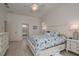 This bedroom features tiled flooring, a large bed, and a doorway that leads into the bathroom at 6129 Schalekamp Dr, Spring Hill, FL 34609