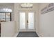 Elegant front door with frosted glass panels, set against a clean, neutral-toned entryway at 6129 Schalekamp Dr, Spring Hill, FL 34609