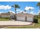 Charming single-story home with a well-manicured lawn, mature landscaping, and three-car garage at 6129 Schalekamp Dr, Spring Hill, FL 34609