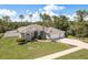 Attractive single-story home featuring a well-manicured lawn and a three car garage at 6129 Schalekamp Dr, Spring Hill, FL 34609
