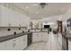 Bright open kitchen with white cabinets, contrasting countertops, and seamless flow to the living area, great for entertaining at 6129 Schalekamp Dr, Spring Hill, FL 34609