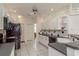 Well-lit kitchen featuring white cabinetry, black appliances, and a tiled backsplash, providing a clean and functional space at 6129 Schalekamp Dr, Spring Hill, FL 34609