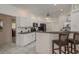 Bright, updated kitchen with white cabinets, a breakfast bar, and open layout, perfect for modern living and entertaining at 6129 Schalekamp Dr, Spring Hill, FL 34609