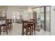 Open-concept layout with a breakfast table, kitchen, and access to an outdoor area, creating a seamless indoor-outdoor flow at 6129 Schalekamp Dr, Spring Hill, FL 34609