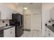 This kitchen features black appliances, white cabinetry, a tiled backsplash, and ample storage space at 6129 Schalekamp Dr, Spring Hill, FL 34609