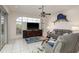 Spacious living room with neutral tones, ample seating, and a view of the pool, perfect for gatherings and relaxation at 6129 Schalekamp Dr, Spring Hill, FL 34609
