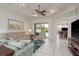 Bright living room with tile floors, recessed lighting, and sliding glass doors to the pool at 6129 Schalekamp Dr, Spring Hill, FL 34609