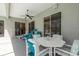 Relaxing covered patio with ceiling fan, plush seating and easy access to the home's interior at 6129 Schalekamp Dr, Spring Hill, FL 34609