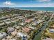An aerial view showcasing the home nestled within a waterfront community with canals and beautiful beaches nearby at 614 Norton St, Longboat Key, FL 34228