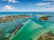 Breathtaking aerial view of the coastal neighborhood, showcasing the beautiful turquoise waters and lush green islands at 614 Norton St, Longboat Key, FL 34228